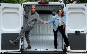 Jurrien and Sara stand in their empty Fiat E-Ducato van ready to get started on the van build