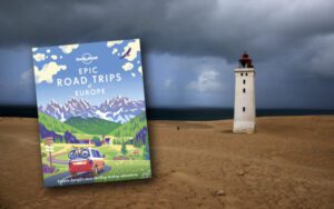 Lonely Planet Epic Drives of Europe book with an image of a lighthouse in Jutland in Denmark in the background